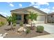 Inviting single-story home featuring a two-car garage and charming desert landscaping at 18032 W Muirwood Dr, Goodyear, AZ 85338