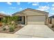 Charming single-story home with a low maintenance desert rock garden at 18032 W Muirwood Dr, Goodyear, AZ 85338