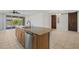 Open kitchen design boasts a large island with stainless steel appliances at 18032 W Muirwood Dr, Goodyear, AZ 85338