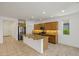 Modern kitchen features granite countertops, stainless steel appliances and tiled flooring at 18032 W Muirwood Dr, Goodyear, AZ 85338