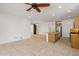 Bright open-concept living area with kitchen featuring a large island and stainless appliances at 18032 W Muirwood Dr, Goodyear, AZ 85338