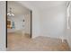 Open-concept living room with tile flooring flowing into the adjacent kitchen at 18032 W Muirwood Dr, Goodyear, AZ 85338