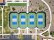 Overhead shot of four well-maintained pickleball courts, with benches and nearby walkways, nestled among desert landscaping at 18032 W Muirwood Dr, Goodyear, AZ 85338