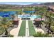 An aerial view of the outdoor amenities showing the pool, bocce ball court, lounge seating, and well maintained landscaping at 18032 W Muirwood Dr, Goodyear, AZ 85338