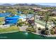 An aerial view of the pool area with a bocce ball court and other outdoor amenities, perfect for relaxation and recreation at 18032 W Muirwood Dr, Goodyear, AZ 85338
