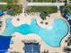 Overhead shot of a refreshing outdoor pool featuring lounge chairs and tables with umbrellas for a relaxing experience at 18032 W Muirwood Dr, Goodyear, AZ 85338