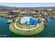 Aerial view of the community pool and rec area featuring a lake and green spaces at 18032 W Muirwood Dr, Goodyear, AZ 85338