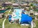 The community pool features covered seating areas, mature palm trees, and plenty of lounge chairs at 18032 W Muirwood Dr, Goodyear, AZ 85338