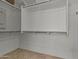 Spacious walk-in closet with adjustable shelving and ample hanging space at 18032 W Muirwood Dr, Goodyear, AZ 85338