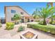 Spacious backyard featuring a fire pit, beautiful desert landscaping, and a covered patio for outdoor living at 18118 N Smith Dr, Maricopa, AZ 85139