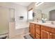 Relaxing bathroom featuring a soaking tub, separate shower, and a double sink vanity at 18118 N Smith Dr, Maricopa, AZ 85139