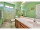 Bright bathroom featuring decorative green wall color, a window, decorative plants, and a shower with curtain at 18118 N Smith Dr, Maricopa, AZ 85139