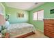 Bright bedroom featuring a window with blinds, side tables, and decorative art pieces at 18118 N Smith Dr, Maricopa, AZ 85139