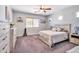 Cozy bedroom with a comfortable queen-sized bed, soft carpet, and a large window at 18118 N Smith Dr, Maricopa, AZ 85139