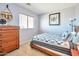 Cozy bedroom featuring window with blinds, a mounted fan and a charming horse-themed art decor at 18118 N Smith Dr, Maricopa, AZ 85139