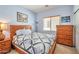 Comfortable bedroom with a wooden bed frame, side tables, and decorative wall art and window at 18118 N Smith Dr, Maricopa, AZ 85139