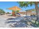 Community playground with slides, play equipment and picnic area under mature shade trees at 18118 N Smith Dr, Maricopa, AZ 85139