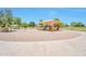 Neighborhood playground with a sunshade, slides, and play equipment situated in a large sandbox at 18118 N Smith Dr, Maricopa, AZ 85139