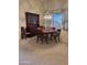 Traditional dining room features a wood table, chairs, china cabinet, and natural light from a large window at 20609 N 57Th Dr, Glendale, AZ 85308