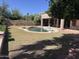 Backyard showcasing a refreshing private pool, grassy area and covered patio at 20609 N 57Th Dr, Glendale, AZ 85308