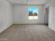 Bedroom featuring neutral carpet, white walls and window with outdoor view at 2127 W Marco Polo Rd, Phoenix, AZ 85027
