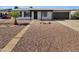 Charming single-story home with desert landscaping, brick walkway, and a dark-colored attached garage at 2127 W Marco Polo Rd, Phoenix, AZ 85027