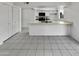 Open kitchen area with white cabinetry, stainless appliances, ample countertop space, and tile floors throughout at 2127 W Marco Polo Rd, Phoenix, AZ 85027