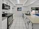 Clean kitchen with stainless steel appliances, tiled floors, white cabinets, and a view to the backyard through a window at 2127 W Marco Polo Rd, Phoenix, AZ 85027