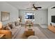 Bright living room featuring neutral tones, plush seating, ceiling fan, and a view to the outside at 2127 W Marco Polo Rd, Phoenix, AZ 85027