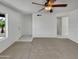 Bright living space with plush carpeting, a ceiling fan, and a view of the front yard through a large window at 2127 W Marco Polo Rd, Phoenix, AZ 85027