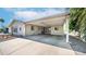 Spacious carport of home showing entrance to backyard, and desert landscaping at 2400 E Baseline Ave # 197, Apache Junction, AZ 85119