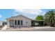 Charming single-story home featuring a covered carport, desert landscaping, and white siding at 2400 E Baseline Ave # 197, Apache Junction, AZ 85119
