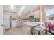 Bright kitchen features white appliances, countertops, and cabinetry with light wood-look flooring at 2400 E Baseline Ave # 197, Apache Junction, AZ 85119