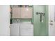 Well-lit laundry room equipped with washer, dryer, and overhead storage cabinets at 2400 E Baseline Ave # 197, Apache Junction, AZ 85119