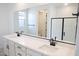 Modern bathroom featuring double sinks, vanity, large mirror, and walk-in shower at 2482 W Rowel Rd, Phoenix, AZ 85085