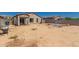 View of the back of a single-story home, with ample yard space ready for a new pool and landscaping at 25539 W Gwen St, Buckeye, AZ 85326