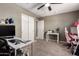 Bedroom featuring a ceiling fan, closet, a desk, and pink gaming chair at 25539 W Gwen St, Buckeye, AZ 85326