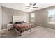 Comfortable bedroom with plush carpeting, neutral walls, and a large window for natural light at 25539 W Gwen St, Buckeye, AZ 85326