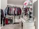 Walk-in closet featuring clothing racks, shoe rack, and a vanity with lighted mirror at 25539 W Gwen St, Buckeye, AZ 85326