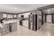Spacious kitchen boasting white cabinets, stainless steel appliances, a pantry, and a center island at 25539 W Gwen St, Buckeye, AZ 85326