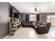 Inviting living room featuring stylish tile floors, a modern ceiling fan, and a comfortable sectional couch at 25539 W Gwen St, Buckeye, AZ 85326