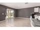 Bright living space featuring tile flooring and an adjacent open-concept kitchen at 25539 W Gwen St, Buckeye, AZ 85326