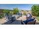 Inviting backyard featuring a paver patio with fire pit and comfortable seating, perfect for outdoor relaxation at 26141 N 133Rd Ave, Peoria, AZ 85383