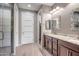 Bathroom featuring double sinks, granite counters, tile floors, and walk-in shower at 26141 N 133Rd Ave, Peoria, AZ 85383