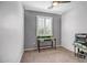 Cozy bedroom with neutral tones, a window, and a desk at 26141 N 133Rd Ave, Peoria, AZ 85383