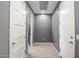 Hallway featuring grey walls, white trim, with doors on either side, and light hardwood floors at 26141 N 133Rd Ave, Peoria, AZ 85383
