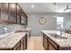 Modern kitchen with granite countertops, stainless steel appliances, and a stylish backsplash at 26141 N 133Rd Ave, Peoria, AZ 85383