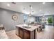 Open-concept kitchen with a large island, pendant lighting, and stainless steel appliances at 26141 N 133Rd Ave, Peoria, AZ 85383