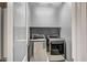 Laundry room featuring side-by-side stainless steel washer and dryer units at 26141 N 133Rd Ave, Peoria, AZ 85383