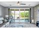 Bright living room boasts a sliding glass door to the backyard and comfortable seating at 26141 N 133Rd Ave, Peoria, AZ 85383